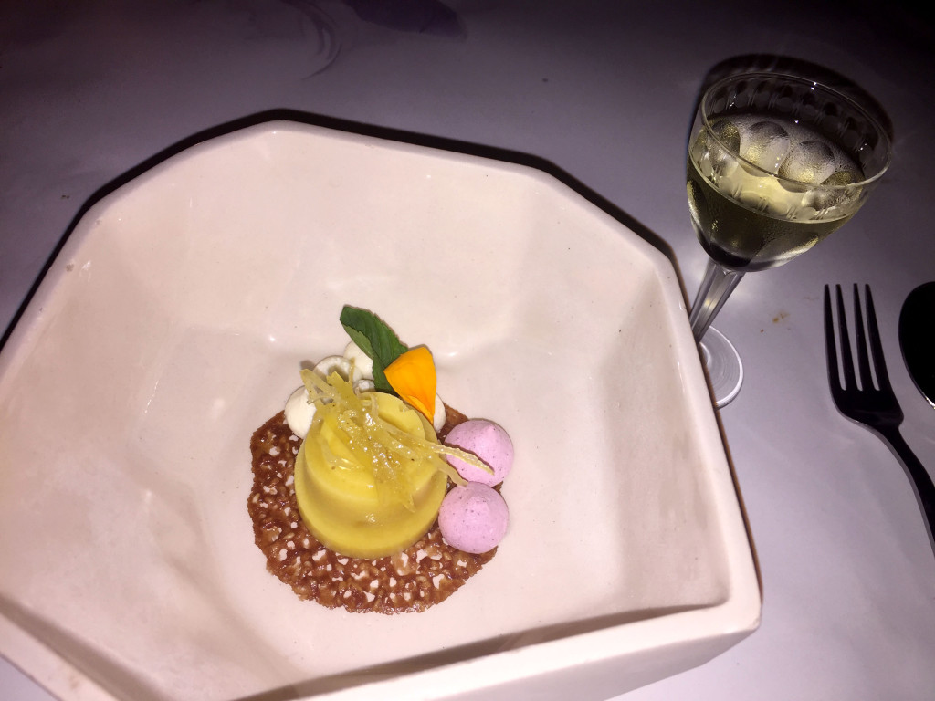 Sweet potato sorbet with creamy goat cheese drops, hibiscus merengue, sesame tuile, candied lemon peels, and flower petal garnish.