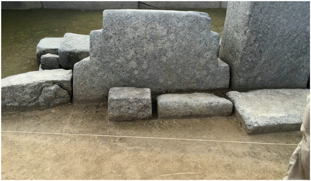 The top half of the Chakana (the "Inca Cross"). It reveals the full symbol when the sun behind it creates its shadow.