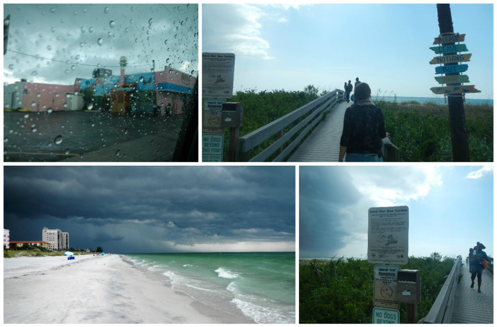 A typical Floridian building is visible through the rainy truck window: pastel pink with turquoise accents. We arrived to Indian Rocks beach, bringing the storm with us. Dark/stormy clouds are visible to the immediate right/south. Indian Rocks beach also gets turtles nesting/hatching from May-Oct, says the sign at the beach access point.