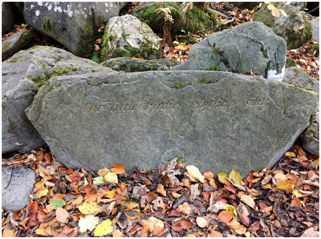 A stanza of the Robert Burns poem "Birks of Aberfeldy" engraved into the stones here. Together they read: "The little birdies blythely sing, / Or lightly flit on wanton wing, In the birks of Aberfeldy. "